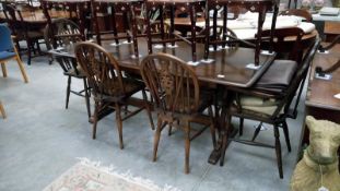 A dark oak farmhouse dining table and a set of 6 wheel back chairs
