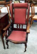 A reclining mahogany framed arm chair by Ray and Miles,
