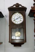 An oak wall clock by The Time Manufacturing Company