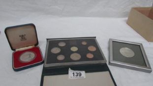 A set of 1983 coins, a 1978 Guernsey 5/- piece and a framed Southwell Minster medallion