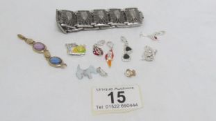 A collection of seven charms including dog charm and a bracelet