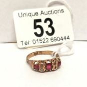 A 9ct gold garnet and diamond chip ring