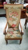 A 19th Century nursing chair with floral tapestry seat