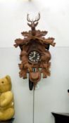 An ornate Black Forest cuckoo clock (One weight and chain need reattaching)