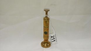 A brass table cigar cutter