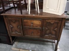 A 1930s oak 2 door 2 drawer sideboard