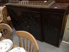 A dark wood stained astragal glazed book case top