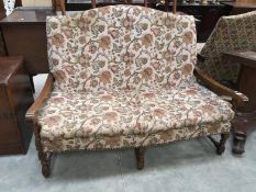 A cottage style oak framed 2 seater settee with fabric decoration