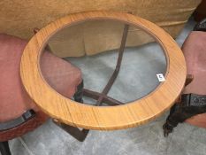 A retro round coffee table with glass top