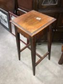 An oak plant stand on tapered legs