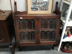 A wall mounted display cabinet with lead glazing