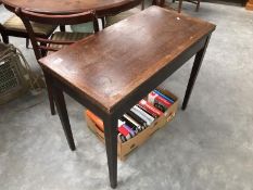 A mahogany fold over card table with tapered legs