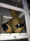 A straw filled old teddy bear with glass eyes