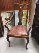 A 1930s oak hall carver chair