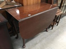 A dark wood stained gate leg table with Queen Anne legs