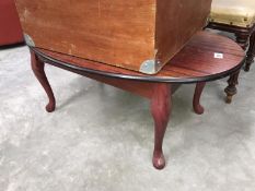 An oval coffee table with Queen Anne legs