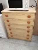 A pine effect bedroom chest of drawers