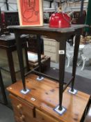 A 1930s oak side table with tapered legs and pad feet