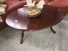 A dark wood stained oval coffee table