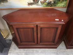 A dark wood stained TV cabinet