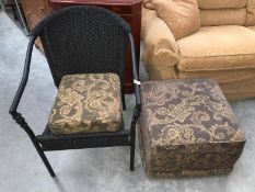 A wicker chair and matching stool