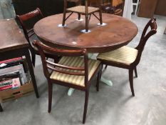 A round dining table with painted pillar base and 4 chairs