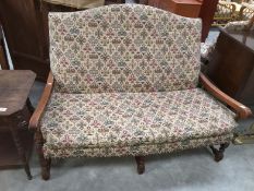 A cottage style oak framed 2 seater settee with fabric decoration