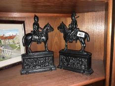 A pair of Victorian cast iron door stops of cavlary men on horse back
