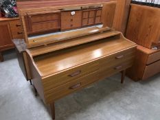 A 1960s teak effect mirror backed dressing table