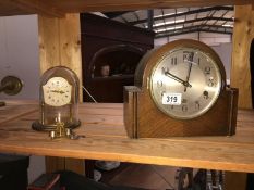 An oak Westminster chime mantel clock and small anniversary clock under dome