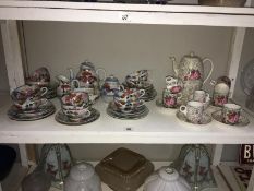 One floral patterned tea set and one Oriental tea set