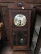 A 1930s oak wall clock