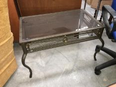 A metal framed glass topped coffee table