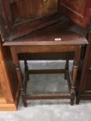 A 1930s oak side table with turned legs