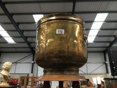 A large brass urn with lion head handles