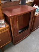 A tamber fronted teak effect TV cabinet