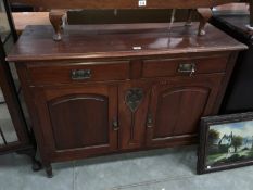 An early 20th C mahogany sideboard with Art Nouveau carvings