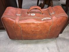 A light brown leather suitcase