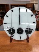 A round modern wall clock with internation times New York, London,