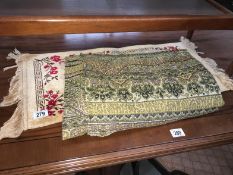 A tapestry throw and a prayer mat