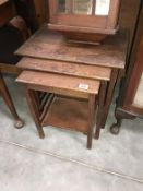 A 1930s oak nest of tables