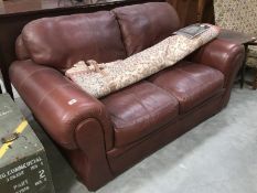 A 2 seater brown leather settee