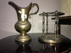 A metal pitcher and metal stand