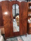 A flame mahogany wardrobe with mirrored door