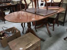 A double pedesal dining table with 1 leaf