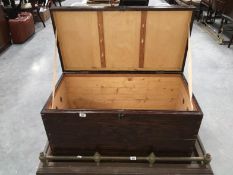 A dark stained pine chest