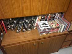 A quantity of DVDs (many James Bond) and CDs