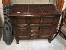 An oak blanket box with cupboard front and doors