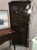 A dark wood stained corner cupboard