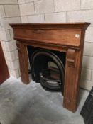 A teak fire surround with Victorian cast iron fire place